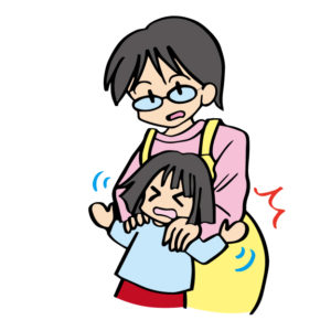 暴れる子どもを押さえる